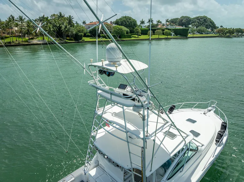 Slide: The Image of 2006 Tiara Yachts 4200 Open on serene water with lush green shoreline. - 33