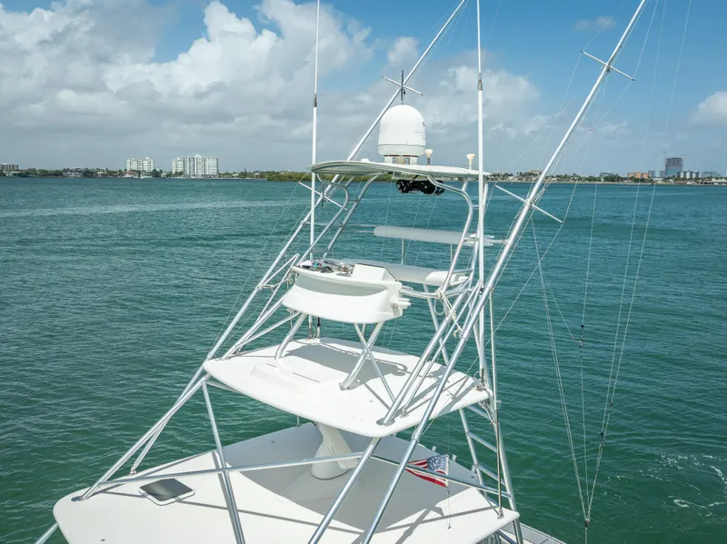 Slide: The Image of 2006 Tiara Yachts 4200 Open with tower, overlooking calm waters and distant cityscape. - 35