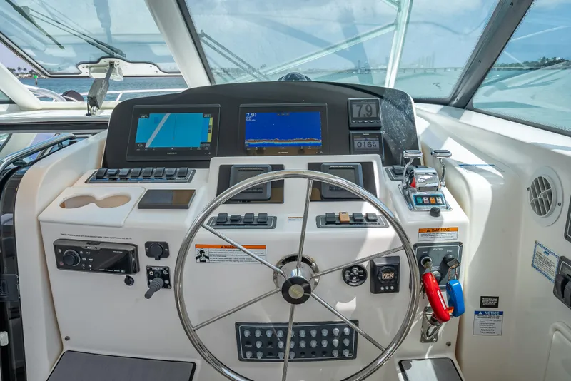 Slide: The Image of Helm of 2006 Tiara Yachts 4200 Open with navigation screens and controls. - 38