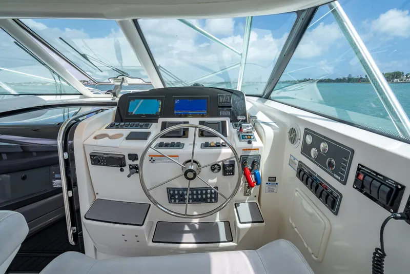 Slide: The Image of Helm of 2006 Tiara Yachts 4200 Open, featuring modern navigation controls and steering wheel. - 39