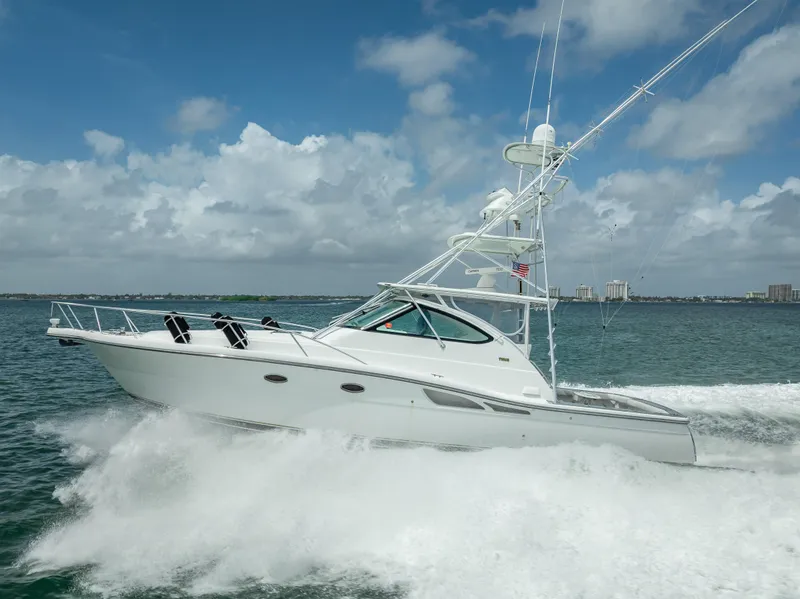 Slide: The Image of 2006 Tiara Yachts 4200 Open cruising on the ocean under a cloudy sky. - 4