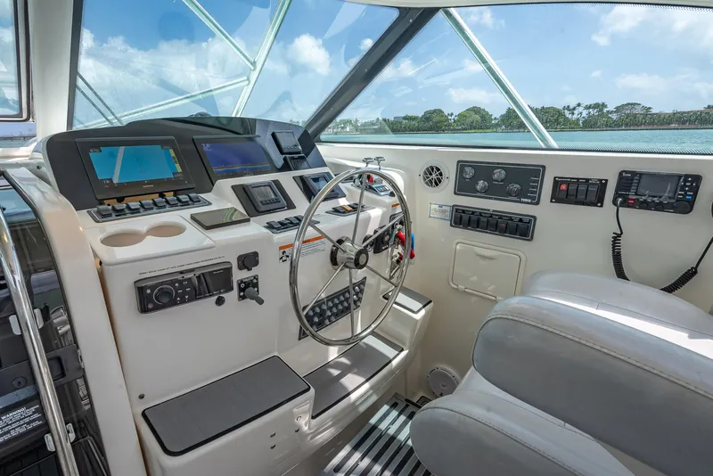 Slide: The Image of 2006 Tiara Yachts 4200 Open helm with modern controls and ocean view. - 41