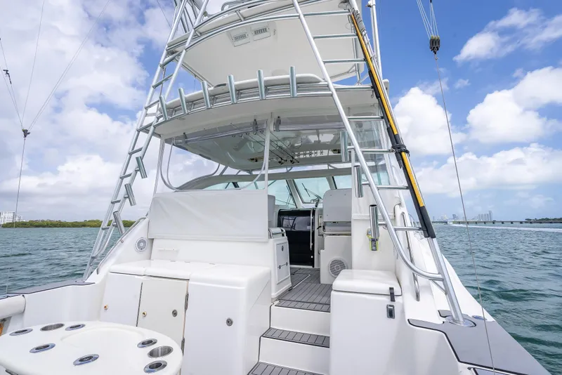 Slide: The Image of 2006 Tiara Yachts 4200 Open, rear view, showcasing deck and ladder under a clear sky. - 46