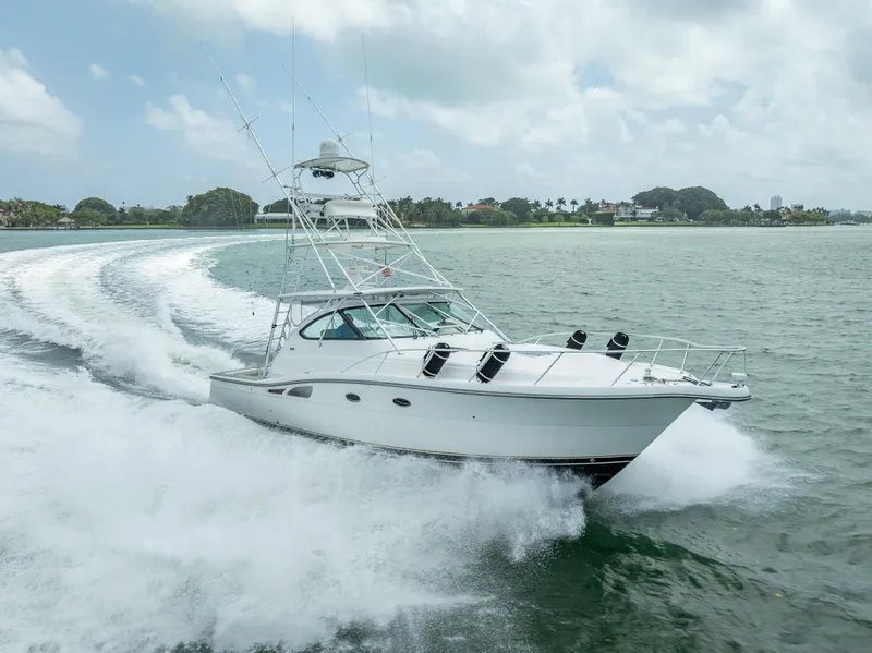 Slide: The Image of 2006 Tiara Yachts 4200 Open cruising on water, creating a dynamic wake. - 5
