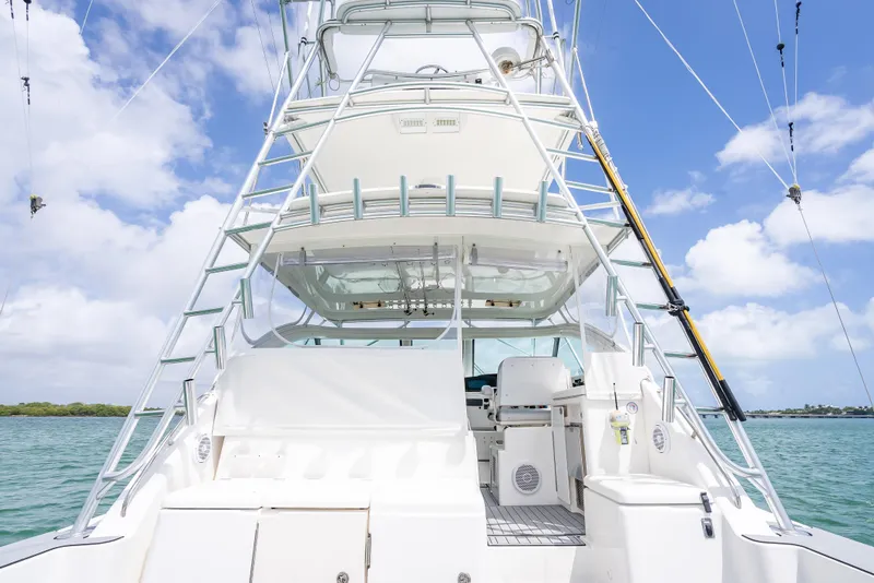 Slide: The Image of 2006 Tiara Yachts 4200 Open, rear view, showcasing deck and tower against blue sky. - 52