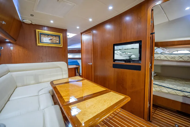 Slide: The Image of Luxurious interior of 2006 Tiara Yachts 4200 Open, featuring wood paneling and cozy seating. - 67