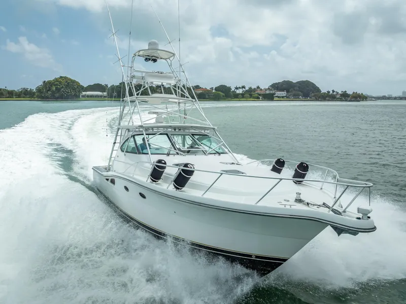 Slide: The Image of 2006 Tiara Yachts 4200 Open cruising on water, showcasing sleek design and powerful performance. - 7