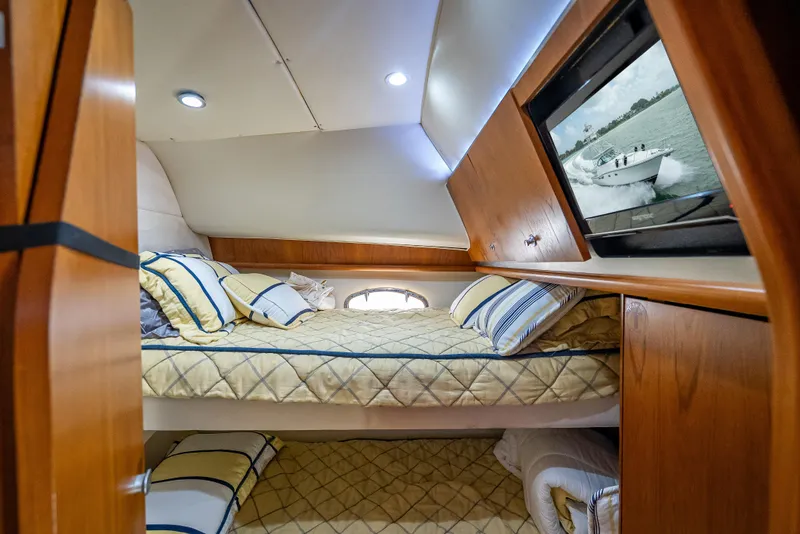 Slide: The Image of 2006 Tiara Yachts 4200 Open cabin with cozy bedding and wooden interior. - 78