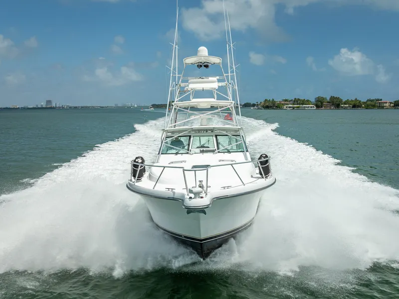 Slide: The Image of 2006 Tiara Yachts 4200 Open cruising swiftly on open water, creating a dynamic wake. - 9
