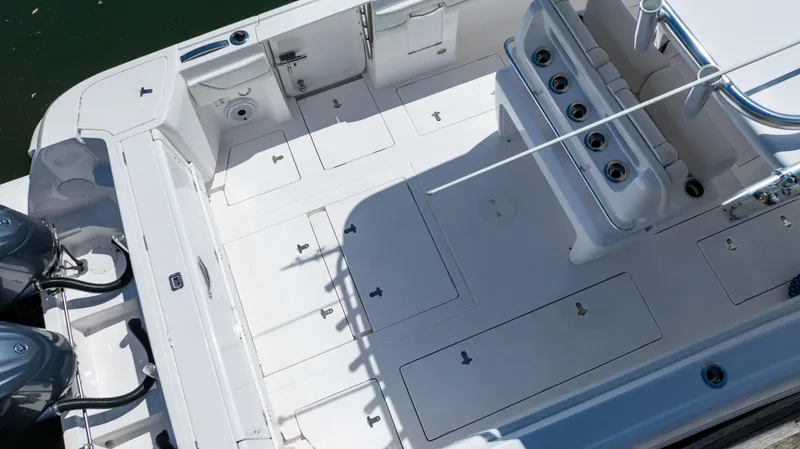 Slide: The Image of 2023 Intrepid 375 Nomad FE boat deck with storage compartments and seating. - 11