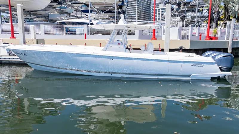 Slide: The Image of 2023 Intrepid 375 Nomad FE boat docked in marina, side view. - 12