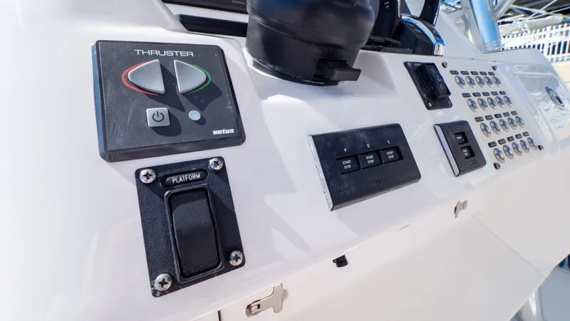 Slide: The Image of Control panel of 2023 Intrepid 375 Nomad FE boat, featuring thruster and switch controls. - 23