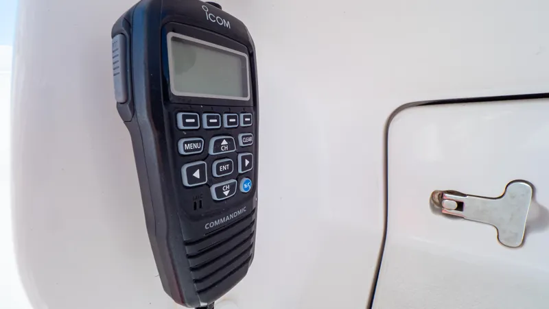 Slide: The Image of Icom marine radio on 2023 Intrepid 375 Nomad FE boat dashboard. - 24