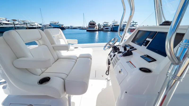 Slide: The Image of 2023 Intrepid 375 Nomad FE boat interior with luxurious seating and advanced navigation controls. - 3