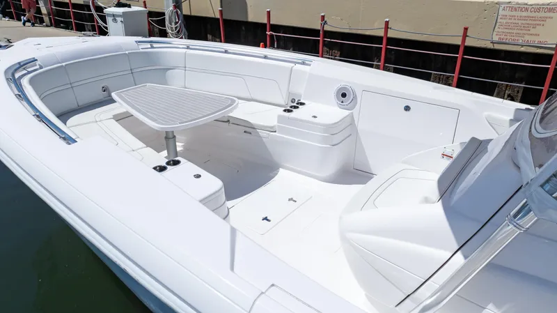 Slide: The Image of 2023 Intrepid 375 Nomad FE boat interior with seating and table. - 30