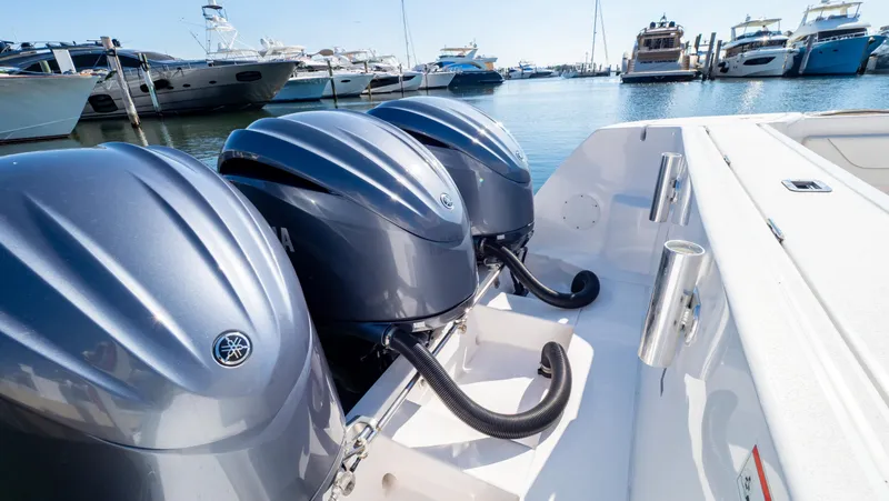 Slide: The Image of 2023 Intrepid 375 Nomad FE with triple outboard engines docked at marina. - 35