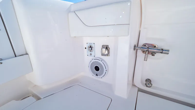 Slide: The Image of 2023 Intrepid 375 Nomad FE boat interior with speaker and utility fixtures. - 38