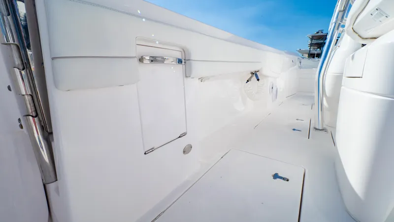 Slide: The Image of 2023 Intrepid 375 Nomad FE boat deck with sleek white design and modern features. - 39