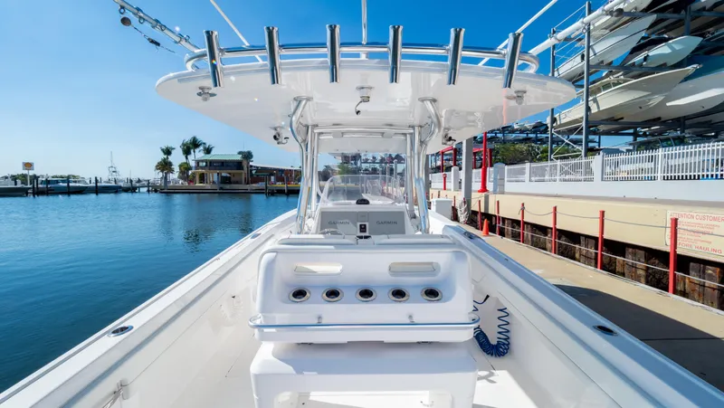 Slide: The Image of 2023 Intrepid 375 Nomad FE boat docked at marina, showcasing sleek design and spacious deck. - 41