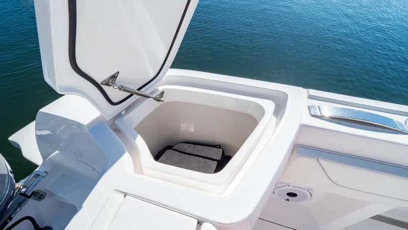 Slide: The Image of Open storage compartment on 2023 Intrepid 375 Nomad FE boat, near water. - 45