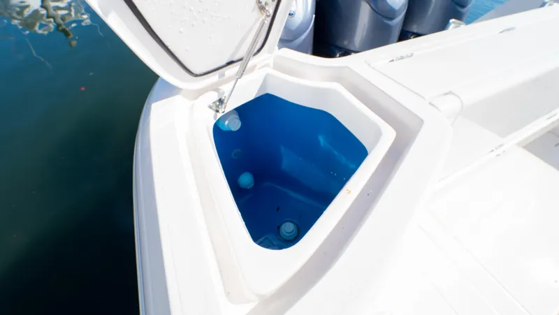 Slide: The Image of 2023 Intrepid 375 Nomad FE boat with open storage compartment, blue interior. - 46