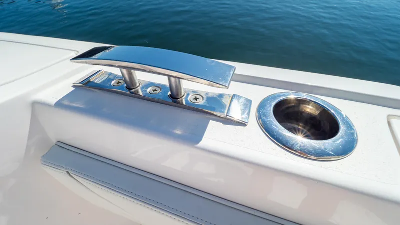 Slide: The Image of 2023 Intrepid 375 Nomad FE boat cleat and cup holder on deck. - 48