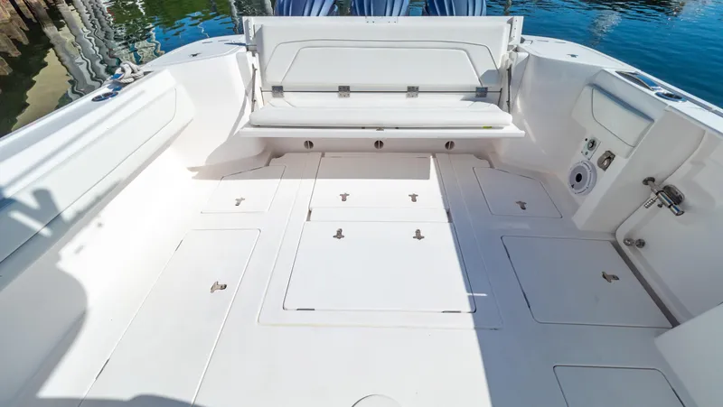 Slide: The Image of 2023 Intrepid 375 Nomad FE boat deck with storage compartments and seating. - 6
