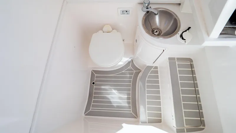 Slide: The Image of 2023 Intrepid 375 Nomad FE boat bathroom with toilet and stainless steel sink. - 7