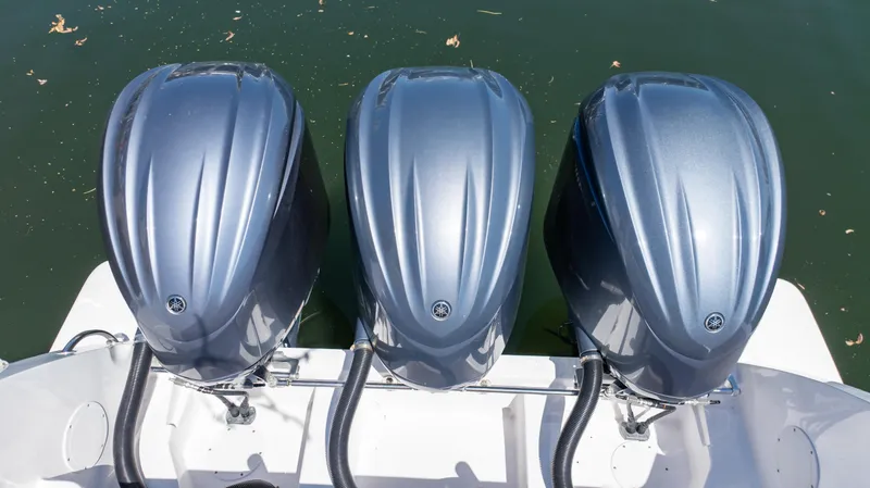 Slide: The Image of Three powerful outboard motors on a 2023 Intrepid 375 Nomad FE boat. - 8