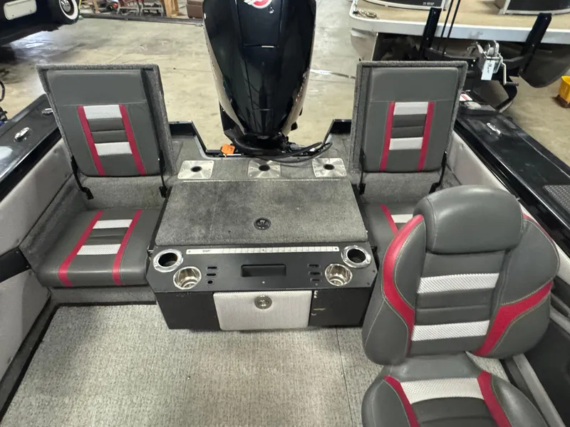 Slide: The Image of 2021 Ranger VX1888 WT boat interior with gray and red seating, cup holders, and motor. - 13