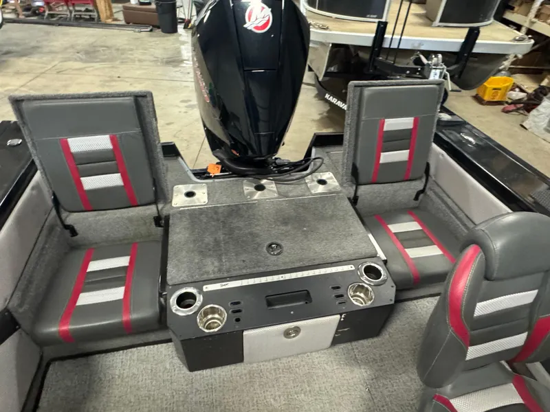 Slide: The Image of 2021 Ranger VX1888 WT boat interior with seating and engine, featuring gray and red upholstery. - 16