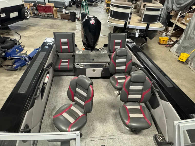 Slide: The Image of 2021 Ranger VX1888 WT boat interior with gray and red seating in a garage setting. - 9