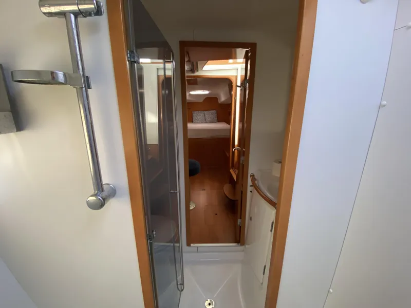 Slide: The Image of Interior view of 2007 Lagoon 380 S2 yacht, featuring a compact bathroom and cozy cabin. - 17