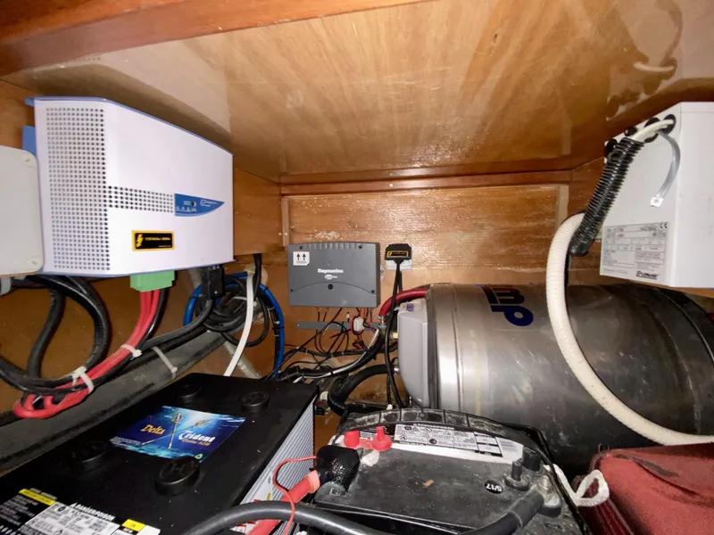 Slide: The Image of Electrical components inside a 2007 Lagoon 380 S2 yacht, featuring batteries and wiring. - 26