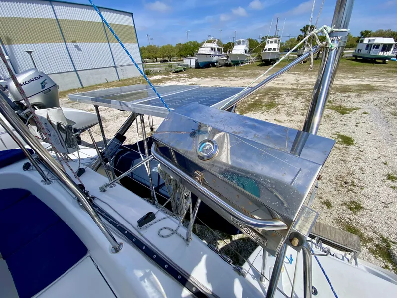 Slide: The Image of 2007 Lagoon 380 S2 yacht with solar panels and outdoor grill, docked in a marina. - 35