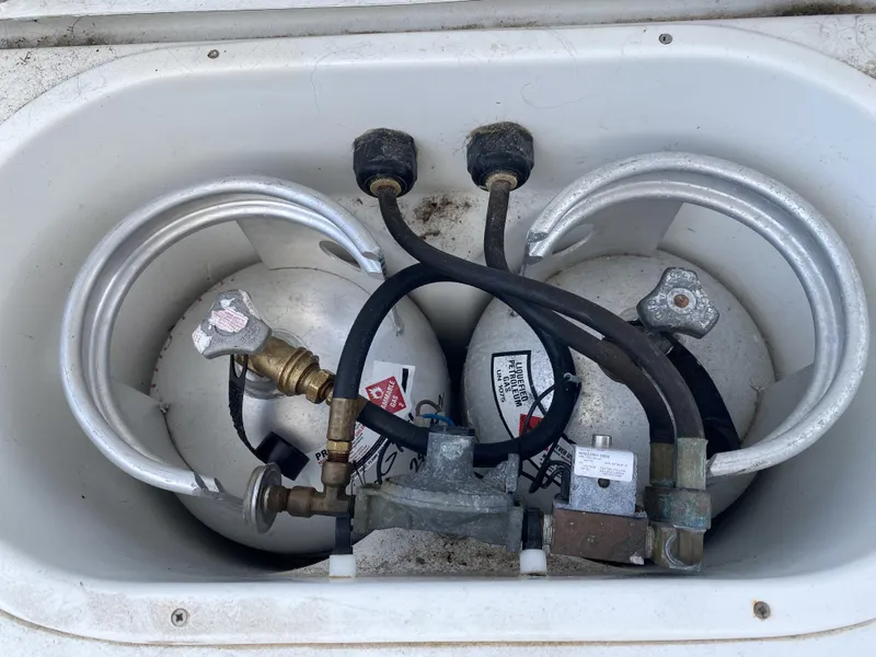 Slide: The Image of Two propane tanks in a storage compartment of a 2007 Lagoon 380 S2. - 38