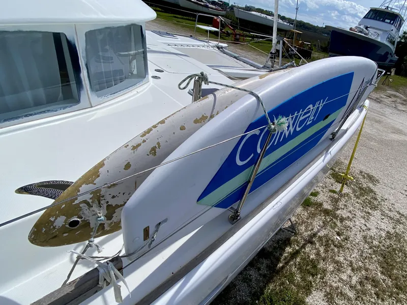 Slide: The Image of Lagoon 380 S2 catamaran with a surfboard on deck, 2007 model. - 40