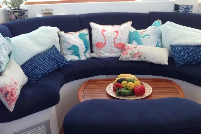 Slide: The Image of Cozy seating area on 2007 Lagoon 380 S2 with colorful cushions and fruit centerpiece. - 41