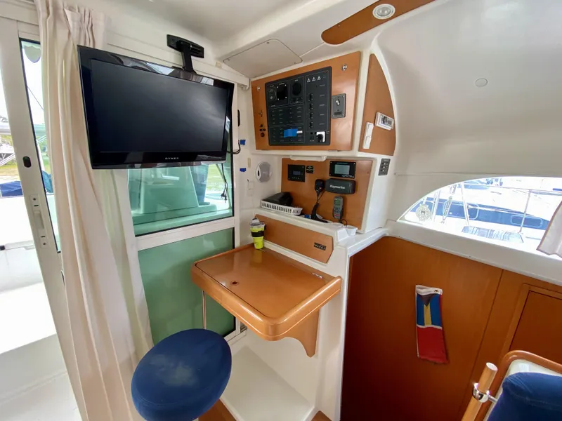 Slide: The Image of Interior of 2007 Lagoon 380 S2 yacht with navigation station and mounted TV. - 7