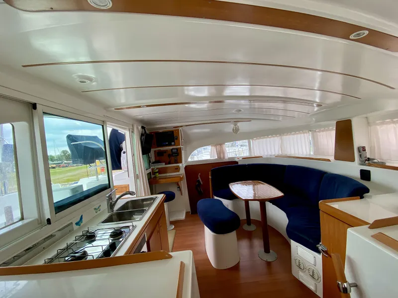 Slide: The Image of Interior of 2007 Lagoon 380 S2 catamaran with kitchen and seating area. - 9