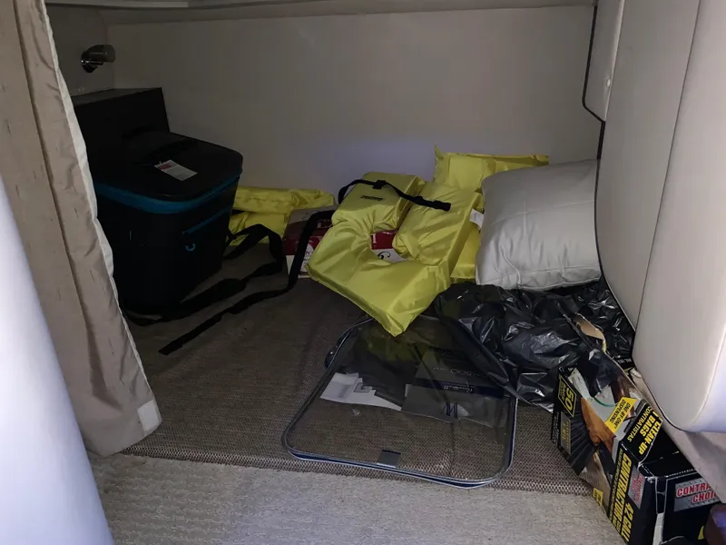 Slide: The Image of Interior cabin of 2017 Sea Ray Sundancer 310 with life jackets and storage items. - 10