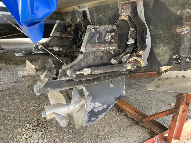 Slide: The Image of 2017 Sea Ray Sundancer 310 with MerCruiser outdrives, showing dual propellers and wear. - 14