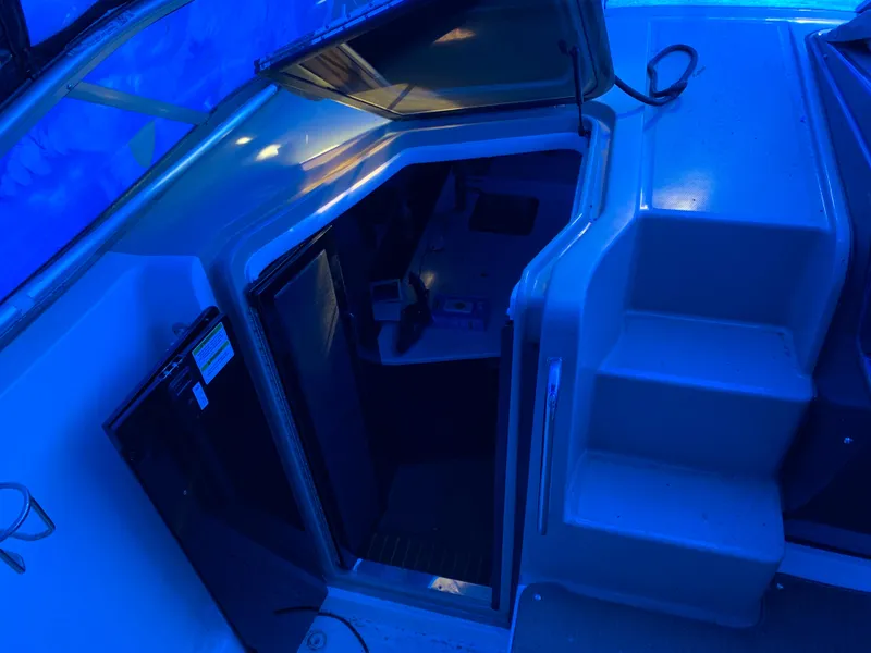Slide: The Image of 2017 Sea Ray Sundancer 310 cabin entrance with blue ambient lighting. - 6