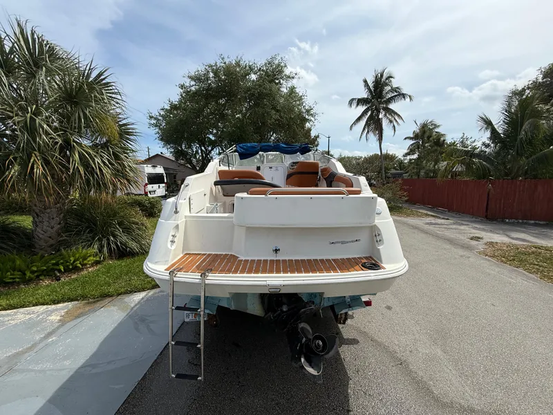 Slide: The Image of 2000 Wellcraft 2400 Martinique boat parked on a sunny street with palm trees. - 10