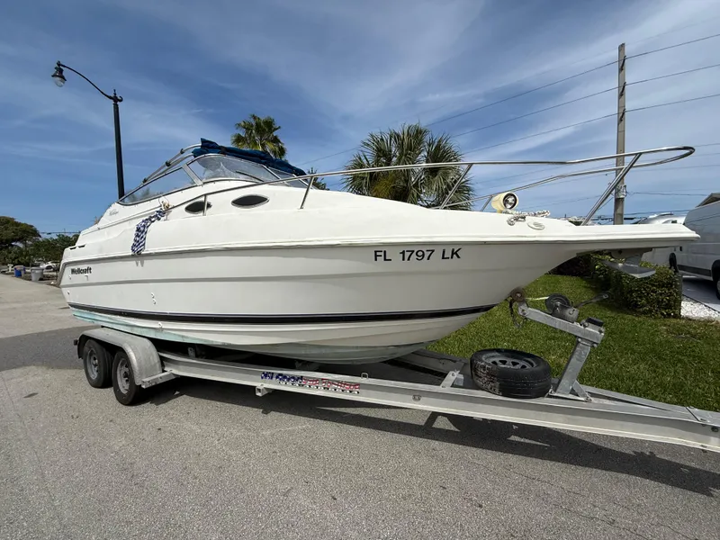 Slide: The Image of 2000 Wellcraft 2400 Martinique boat on trailer, parked on street. - 14