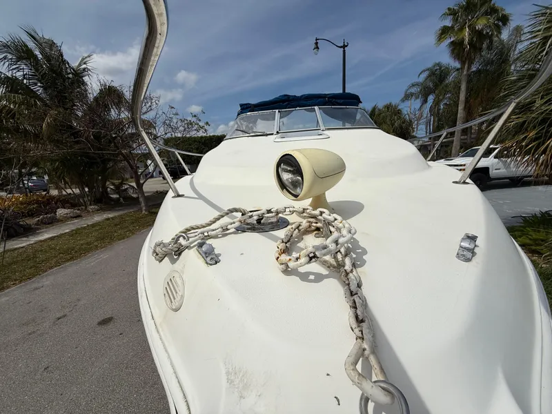 Slide: The Image of 2000 Wellcraft 2400 Martinique boat with anchor chain and spotlight on deck. - 21