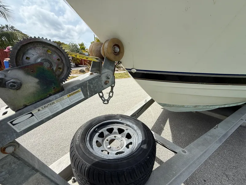 Slide: The Image of 2000 Wellcraft 2400 Martinique boat on trailer with spare tire and winch. - 22
