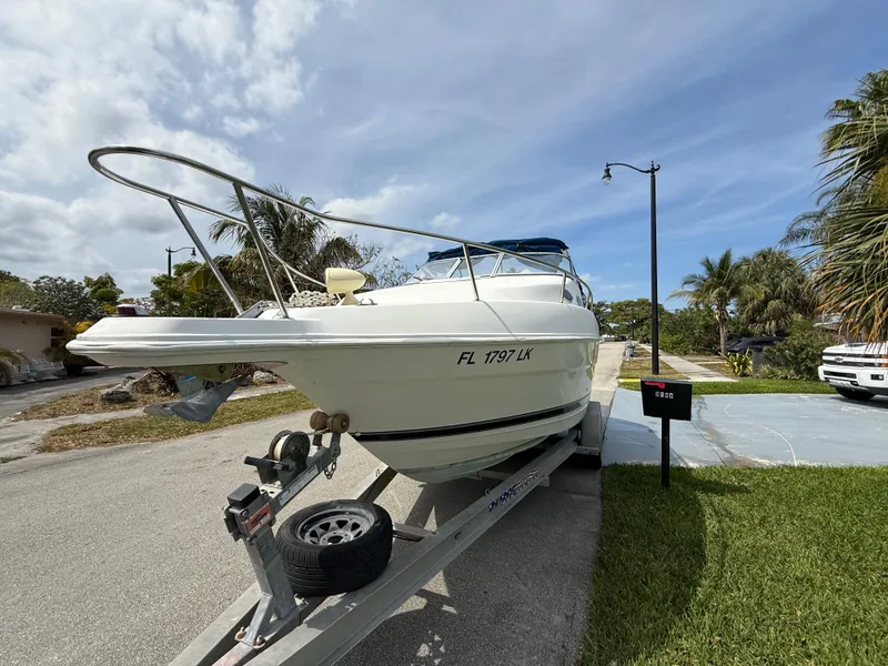 Slide: The Image of 2000 Wellcraft 2400 Martinique boat on trailer, parked in residential area. - 24