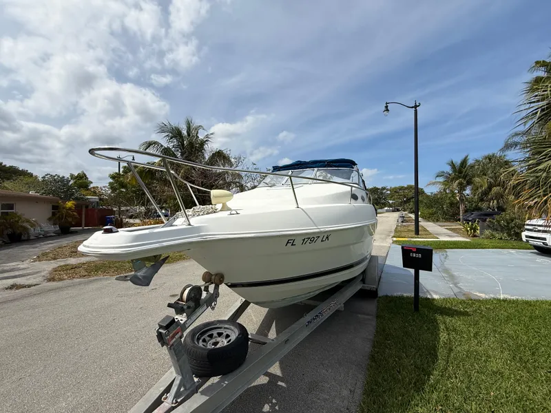 Slide: The Image of 2000 Wellcraft 2400 Martinique boat on trailer, parked in a residential area. - 25