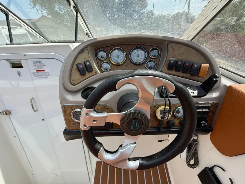 Slide: The Image of Steering wheel and dashboard of 2000 Wellcraft 2400 Martinique boat. - 39